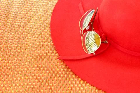 Sunglasses on red hat 스톡 사진