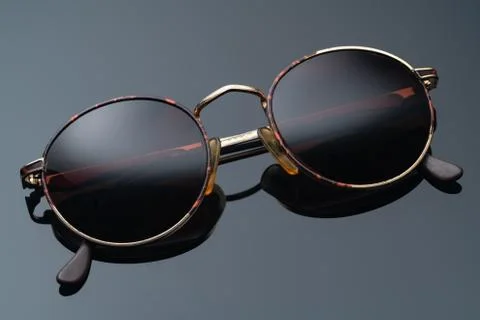 Sunglasses with round frame on dark background Stock Photos