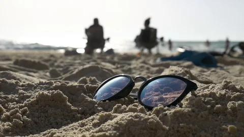 Sunglasses on the sand on the background of the sea. 스톡 동영상 78564269