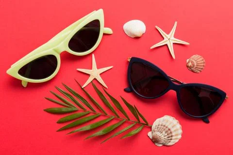 Sunglasses with seashell lying on table background. Sunglasses on summer back 写真素材