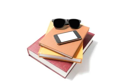Sunglasses smartphone and stack of book Stock Photos