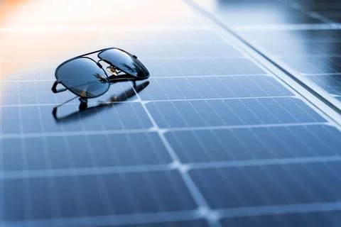Sunglasses on a solar panel with copy space Stock Photos
