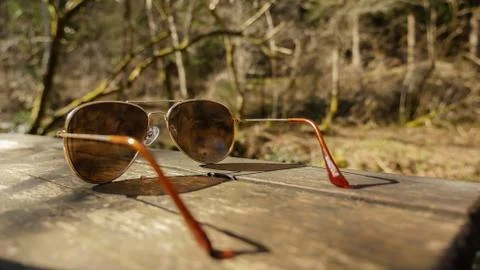 Sunglasses on table in nature Stock Photos