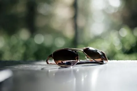 Sunglasses   on a   table.  Selective focus. Bokeh background Foto stock