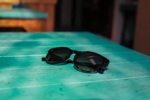 Sunglasses on a table in the sunlight Photos