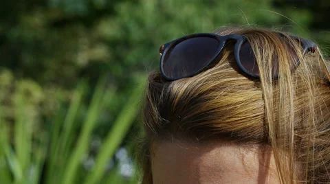 Sunglasses on top of a female's head - summer concept Stock Footage