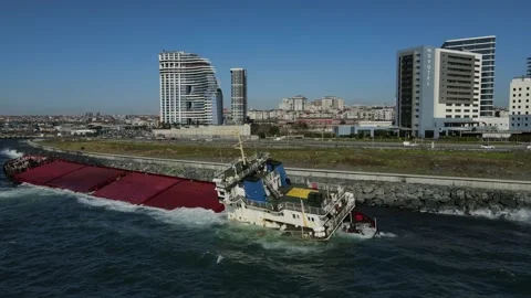 A sunken cargo ship that hit the shore is damaging the environment. Stock Footage 148430348