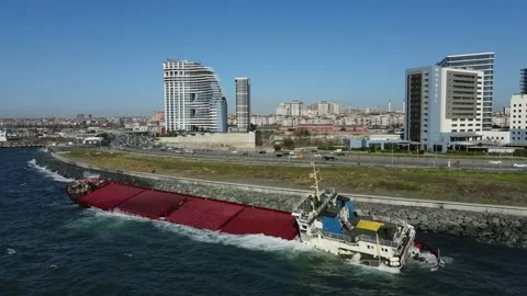 A sunken cargo ship that hit the shore is damaging the environment. Stock Footage 148430880