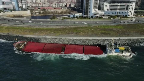 A sunken cargo ship that hit the shore is damaging the environment. Stock Footage 148431045