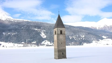 Sunken clock tower in the iced lake of Resia (Reschensee) Stock Footage 94142182