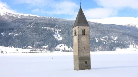 Sunken clock tower in the iced lake of Resia (Reschensee) Stock Footage 94142207