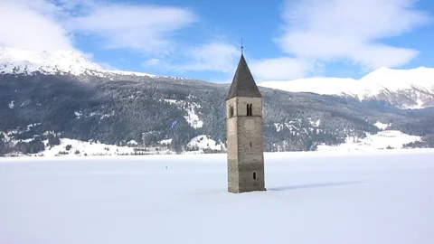 Sunken clock tower in the iced lake of Resia (Reschensee) Stock Footage 94142230