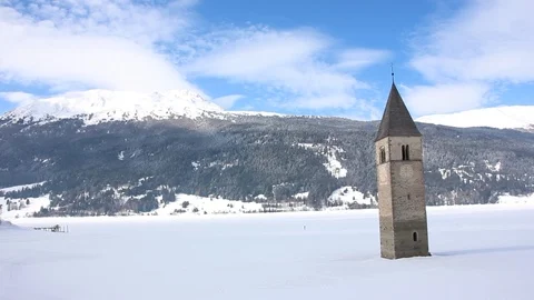 Sunken clock tower in the iced lake of Resia (Reschensee) Stock Footage 94142231