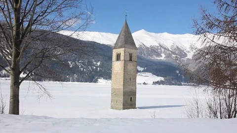 Sunken clock tower in the iced lake of Resia (Reschensee) Stock Footage 94142257