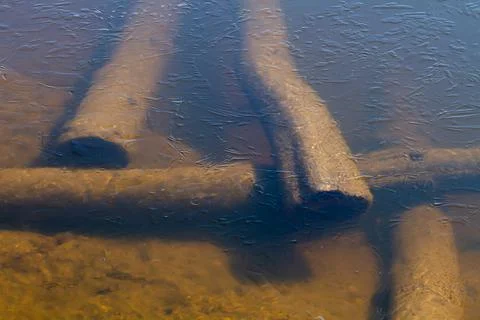 Sunken logs lie at the bottom of the river Stock Photos