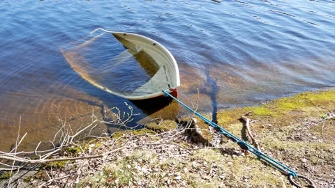 Sunken rowing boat on the shore Stock Footage 154291478