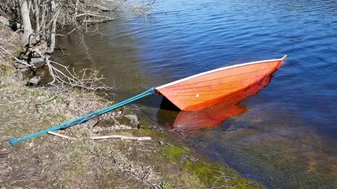 Sunken rowing boat on the shore Stock-Footage 154291566