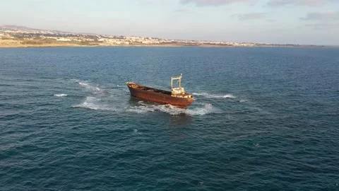 The sunken rusty ship has been lying on the rocks for many years. Stock Footage 139866673