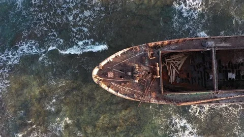 The sunken rusty ship has been lying on the rocks for many years. Stock Footage