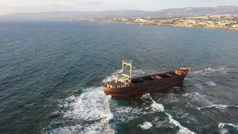 The sunken rusty ship has been lying on the rocks for many years. Stock Footage 139867228