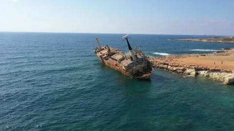 The sunken rusty ship was thrown on the rocks near the shore. Stock Footage 139680308