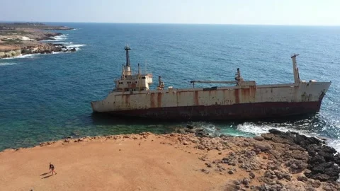 The sunken rusty ship was thrown on the rocks near the shore. Stock Footage 139680710