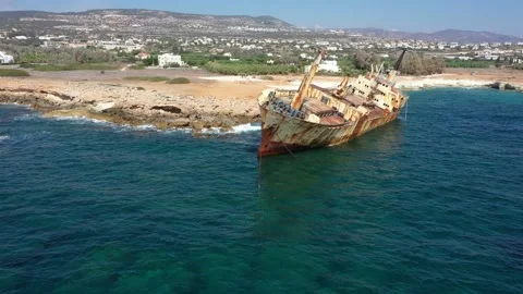 The sunken rusty ship was thrown on the rocks near the shore. Stock Footage 139680736