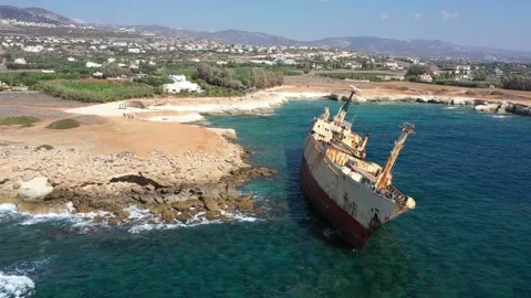 The sunken rusty ship was thrown on the rocks near the shore. Stock Footage 139680931