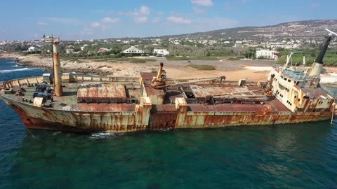 The sunken rusty ship was thrown on the rocks near the shore. Stock Footage 139681400