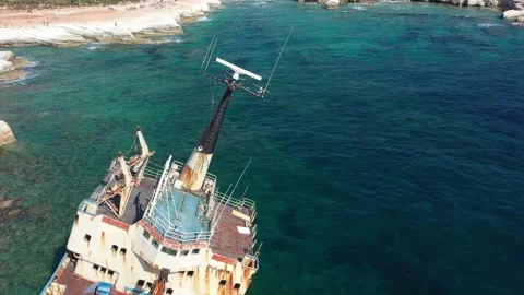 The sunken rusty ship was thrown on the rocks near the shore. Stock Footage 139681403
