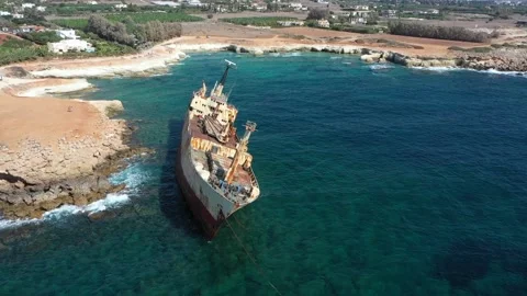 The sunken rusty ship was thrown on the rocks near the shore. Stock Footage 139682500