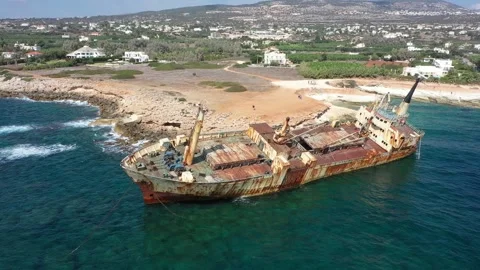 The sunken rusty ship was thrown on the rocks near the shore. Stock Footage 139682586