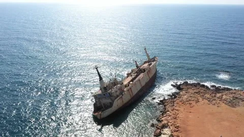 The sunken rusty ship was thrown on the rocks near the shore. Stock Footage 139683264