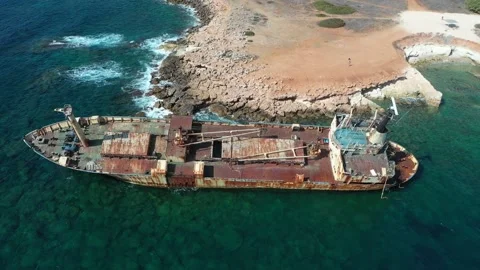 The sunken rusty ship was thrown on the rocks near the shore. Stock Footage 139683495