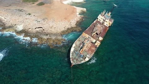 The sunken rusty ship was thrown on the rocks near the shore. Stock Footage 139684035