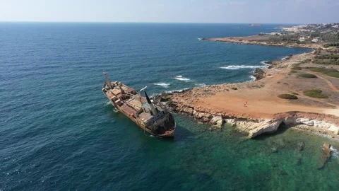 The sunken rusty ship was thrown on the rocks near the shore. Stock Footage 139684359