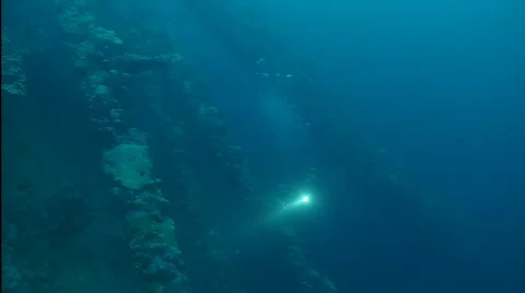 Sunken ship, scuba diver with torch Stock Footage