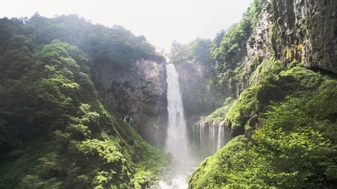 Sunlight Against High Waterfall among Green Moss Covered Rock Stock Footage 129302829