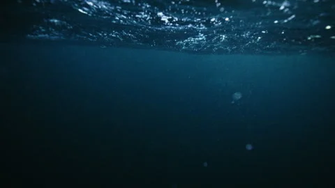 Sunlight and Bubbles Beneath Arctic Ocean Surface Waves Stock Footage 334056658