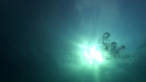 Sunlight and bubbles through deep water Stock Footage 33111088