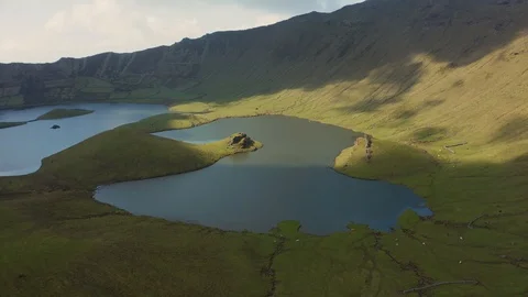 Sunlight and cloud shadows on green slopes of Caldeirao. Aerial of Corvo, Azores Stockbeeldmateriaal 117306108