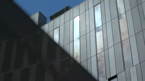 Sunlight and clouds reflecting off office building in Glasgow, Scotand Stock Footage 135211379