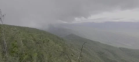 Sunlight and rain over lush green valley landscape Stock-Footage 329072499