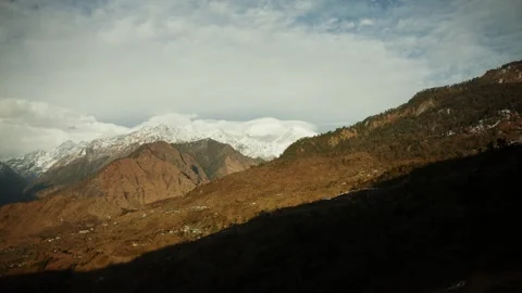 Sunlight and shadow across terraced Himalayan valley village Nepal Stock Footage 342139864