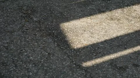 Sunlight and Shadow Patterns on City Park Pillars Stock Photos