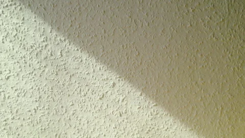 Sunlight and Shadow on Textured Interior Wall Stock Footage 332139628
