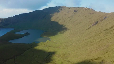 Sunlight and shadows on green slopes of Corvo volcano. Aerial shot of Caldirao Stockbeeldmateriaal 119600508