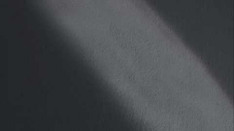 Sunlight and shadows move along the textured wall. Stock Footage 339894975