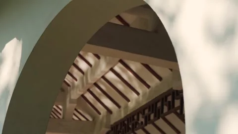 Sunlight and tree shadows cast on traditional architectural archway and wooden Stock Footage 342332294