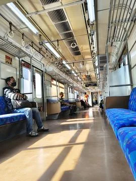 Sunlight and window shadows on the floor of a moving commuter train. Stock-Fotos